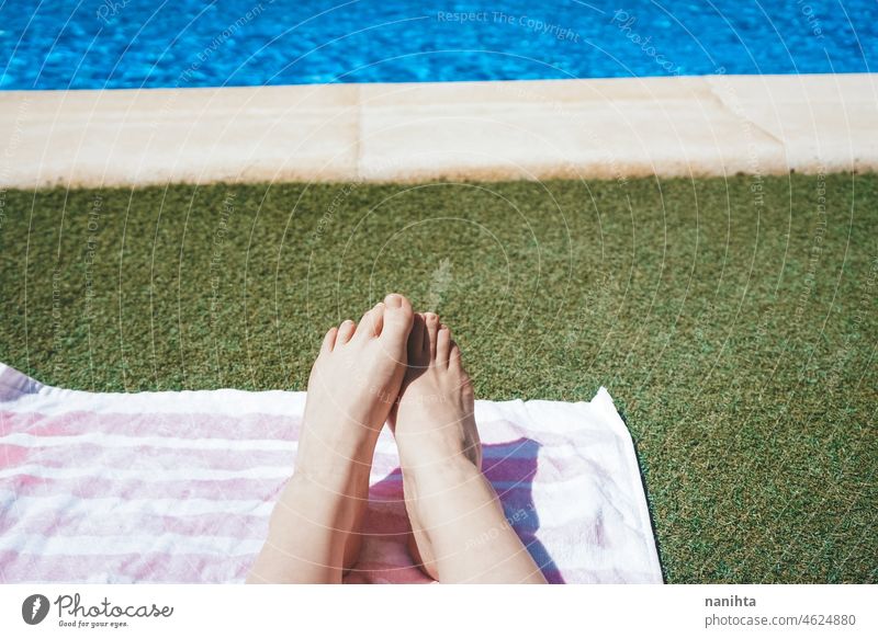 Feet and legs of a woman in a swimming pool feet summer summertime barefoot holidays barefeet water hot tan sun sunny sunbath season seasonal skin white