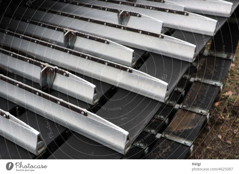 Detail of metal bars on the chains of a snow groomer in the ski area Snowcat Crawler vehicle Tracked vehicle Ski resort Slope roller Snow crawler