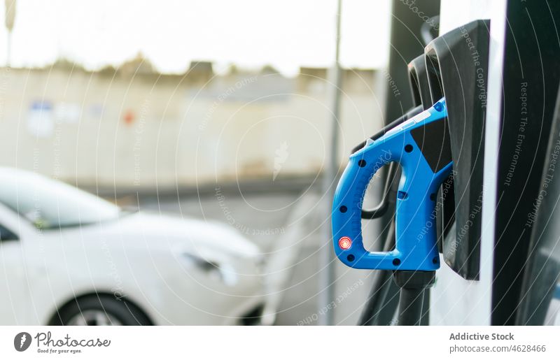 Charging point in city car park electric vehicle power alternative energy battery cable charge charging charging station eco electric car electricity