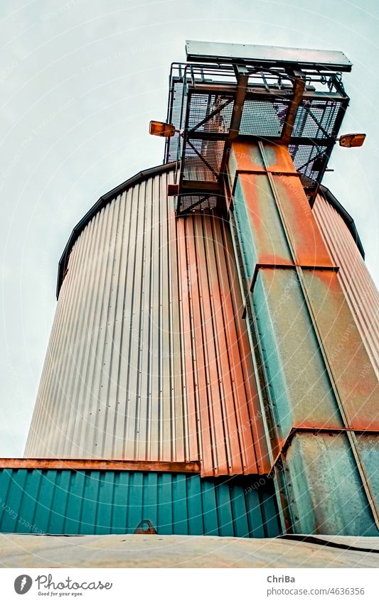 Industrial plant in teal and orange look Industry Rust Silo Tower Factory Exterior shot Metal Steel Deserted Manmade structures Industrial architecture