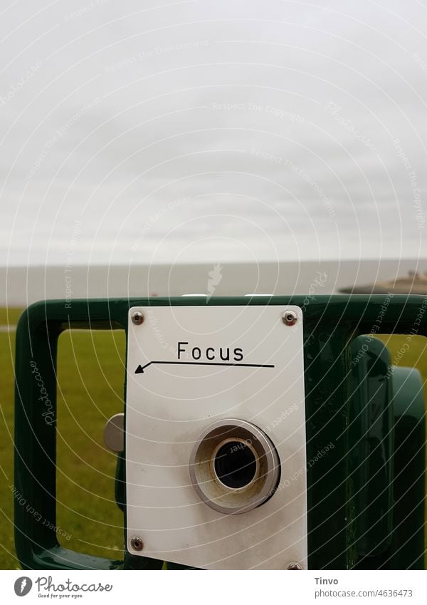 Binoculars in front of landscape with the word Focus above the viewfinder Nature far vision Landscape Vantage point Colour photo Panorama (View) Far-off places