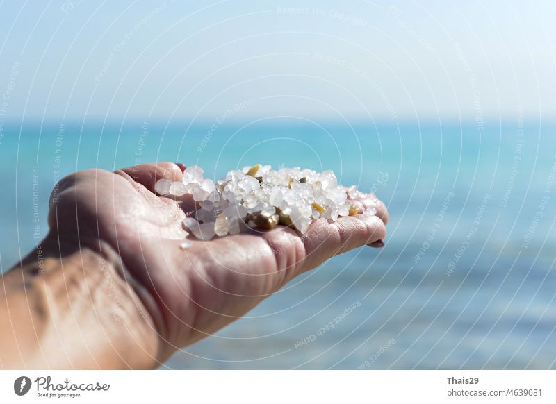 Sea salt crystals in women hand natural mineral formation at the Dead Sea. holding sea salt crystals in hand. hands and white natural crystal salt. A handful of salt
