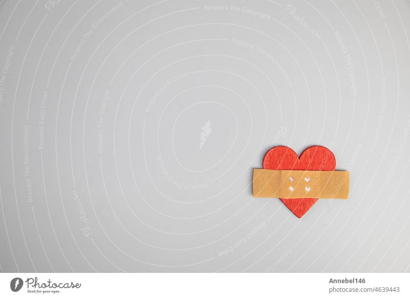 Heart with medical patch on grey background, top view. Relationship problems concept broken heart fix, Valentines Day, medical health concept cross with copy space top view