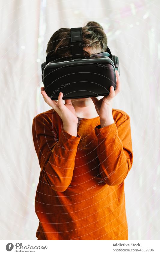 Boy exploring cyberspace in VR glasses child virtual reality explore boy experience vr goggles kid headset gadget device innovation digital futuristic simulate