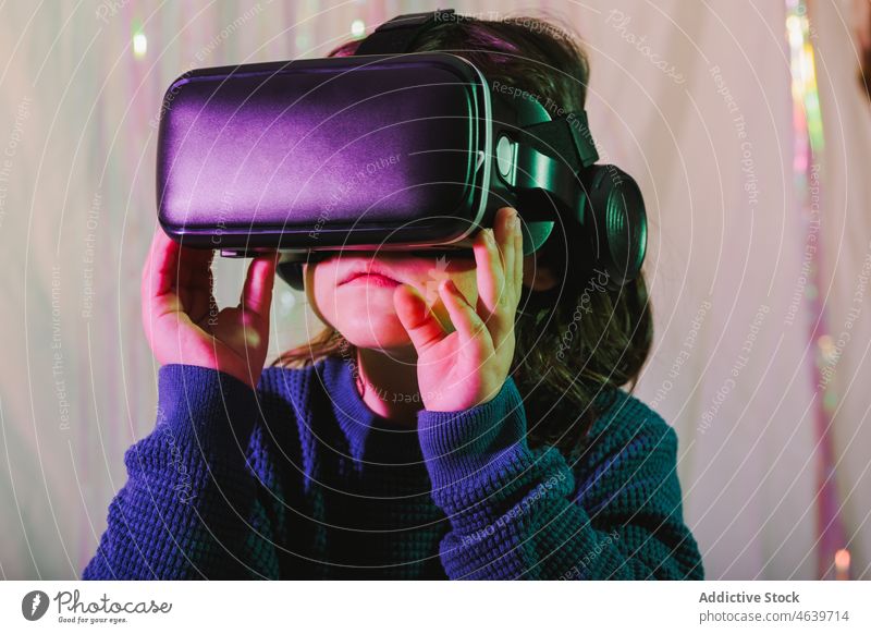 Girl exploring cyberspace in VR glasses child virtual reality explore girl experience vr goggles kid headset gadget device innovation digital futuristic