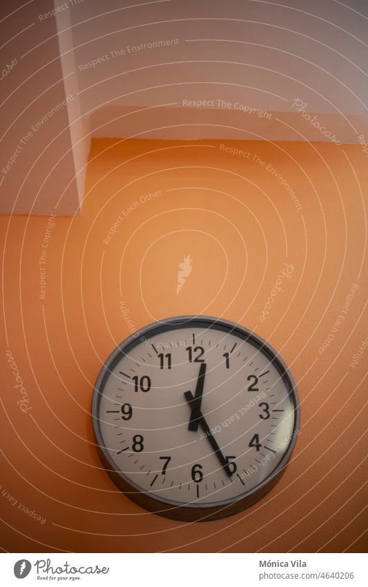 Round wall clock on an orange wall watch round numbers time schedule white Clock Digits and numbers Alarm clock Wake Time lack of time time change Sleep