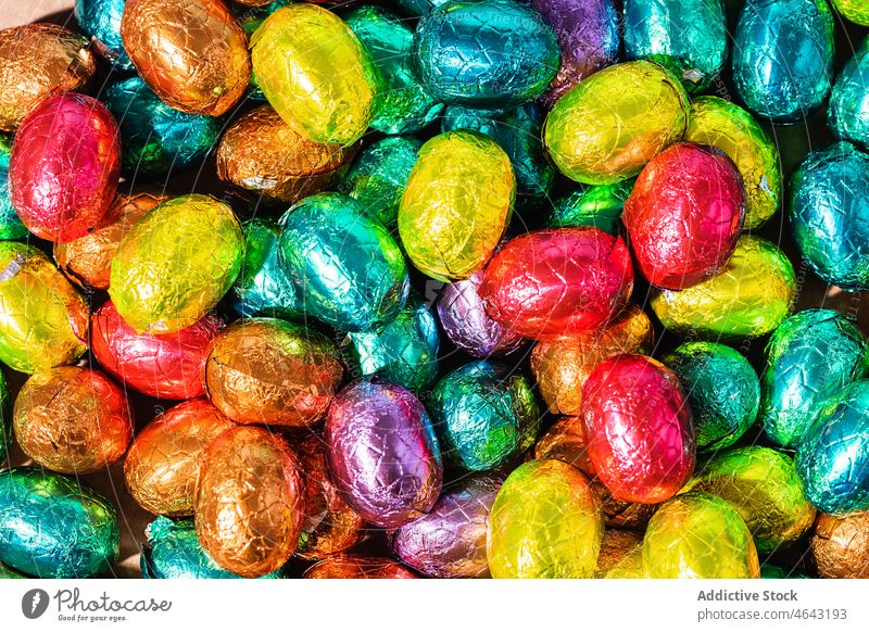 Over Head Shot Of Colourful Chocolate Easter Eggs On Table egg easter easter egg blue chocolate foil holiday food celebration background sweet no people candy
