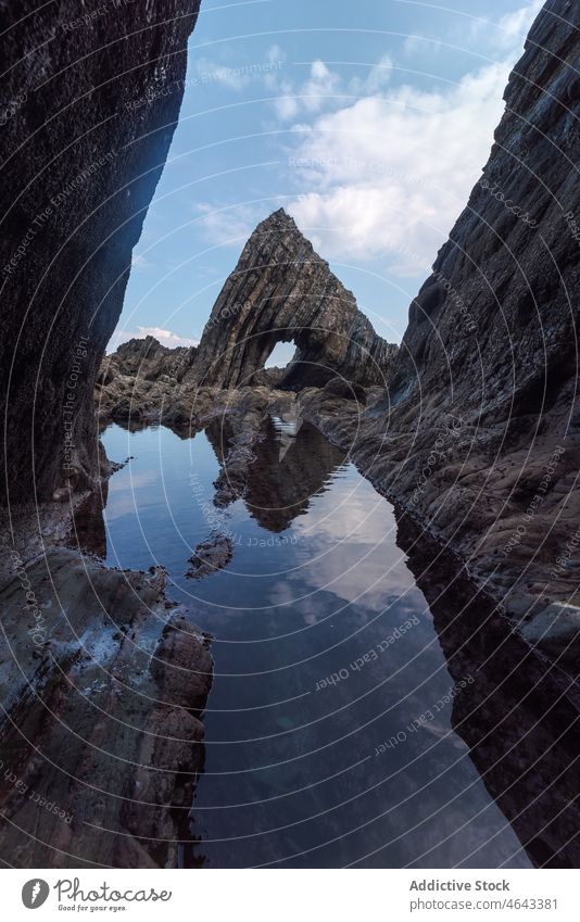 Rocky formations in flowing sea rock cliff water nature stone mountain rocky cave seawater asturias spain rough cloudy playa del silencio environment scenery