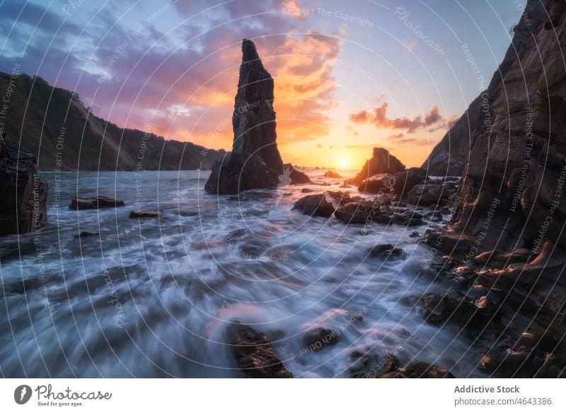 Rocky formations in flowing sea rock cliff water nature stone mountain sunset rocky sundown sunrise seawater asturias spain rough cloudy playa del silencio