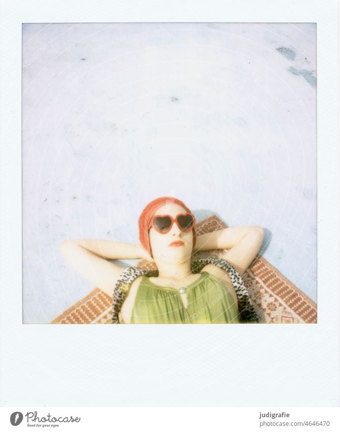 The girl with the beautiful red bathing cap and green swimsuit is sunbathing. A summer love. Polaroid Sunbathing Relaxation Youth (Young adults) Lifestyle