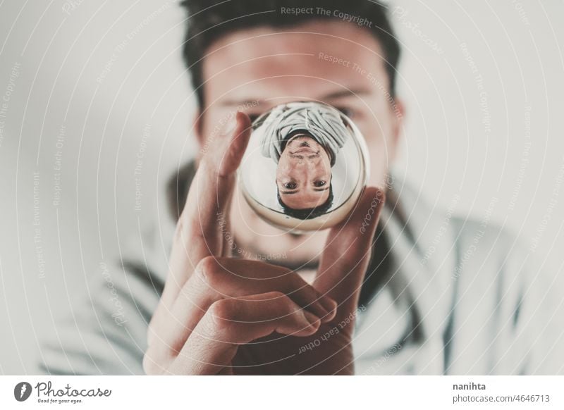 Portrait of a young man viewed through a crystal ball male face distortion abstract surreal magical lens portrait reflected reflection guy white caucasian