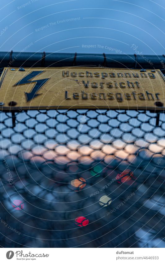 Warning sign on grille at train station at dusk Grating esteem Prohibition sign bokeh Evening Train station Signage Signs and labeling Warning label Safety