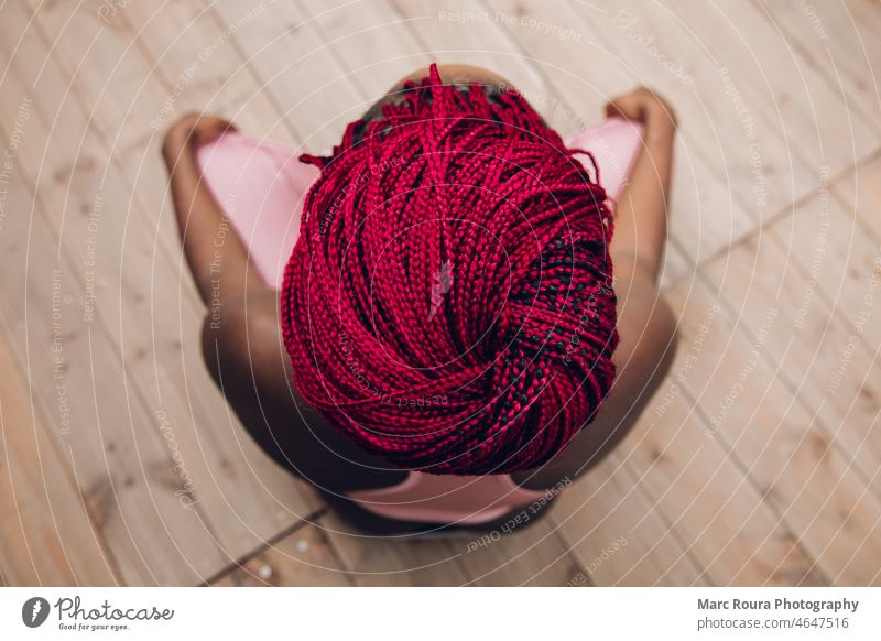 closeup of the red braids of a woman doing meditation active slim activity asana african american athletic trainer balance beauty adult concept health