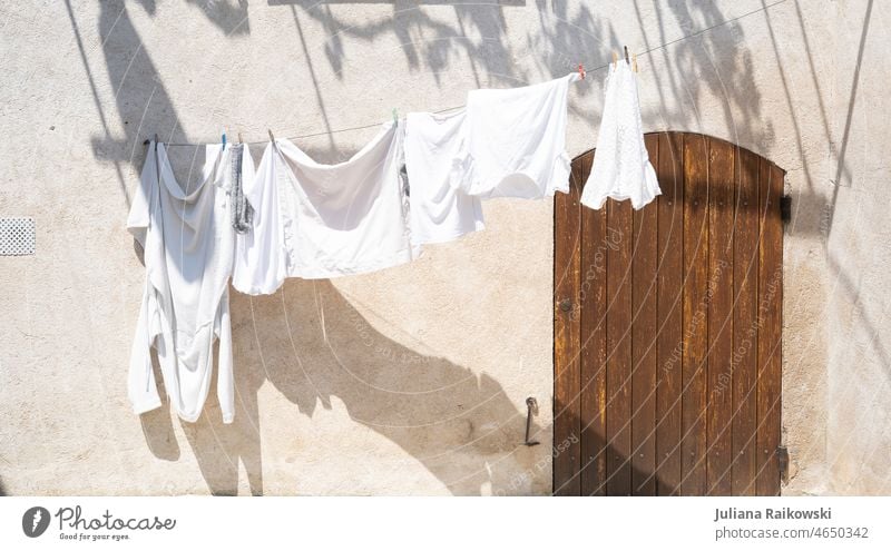 Clothesline in the sun with white laundry clothesline Laundry Dry Washing Washing day Household Hang up Clean Housekeeping Living or residing Fresh