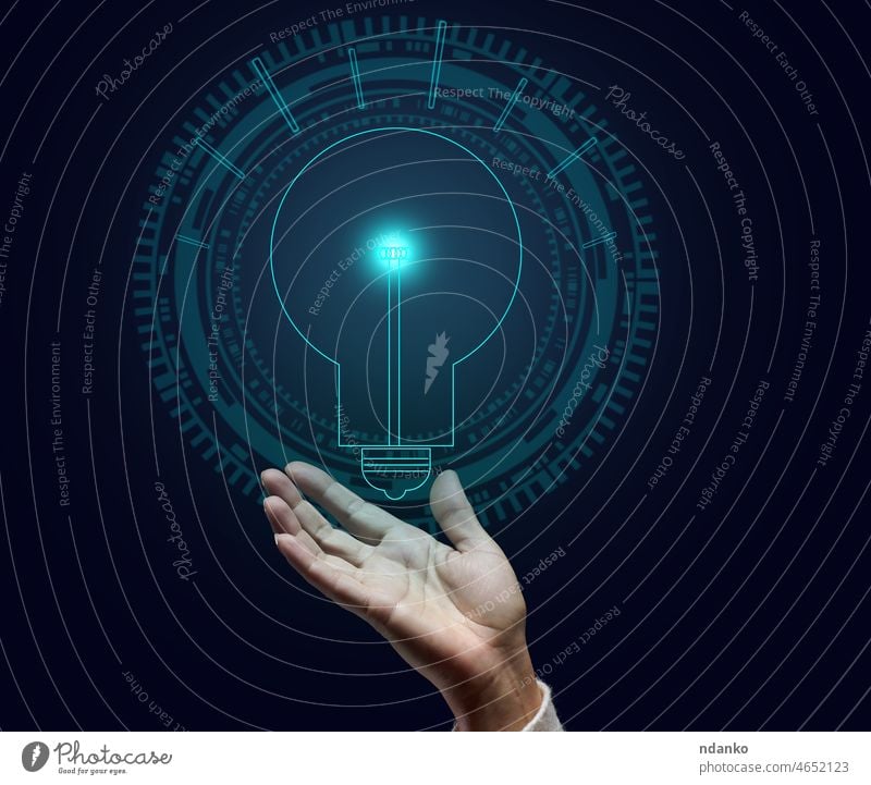 holographic lamp and female hand on a dark blue background. Concept of new ideas, brainstorming. Opening a profitable business energy light bulb concept power