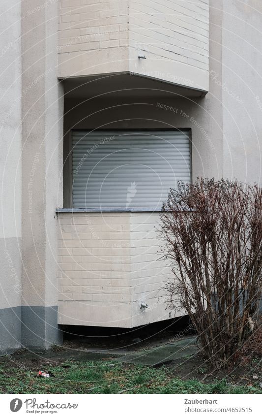 Balcony, closed shutter and facade of drab apartment building roller shutter Closed Flat (apartment) Apartment Building Gloomy Gray shrub Town dwell Lonely