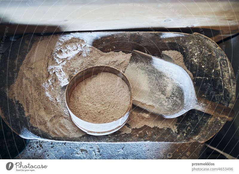 Sifting flour. Bolting flour. Flour in wooden bowl. Old rustick kitchen utensils wheat boult organic rural old sifter antique food bolt grain vintage powder