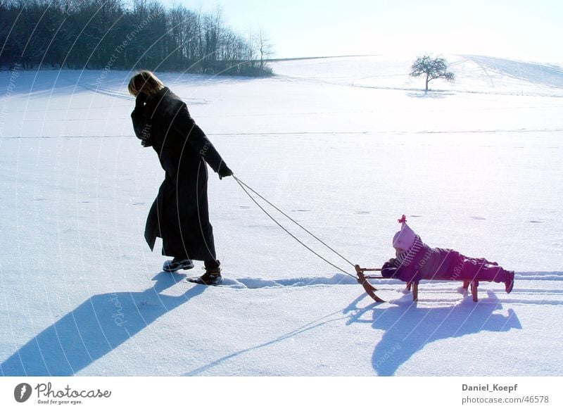 family life Sleigh Sledding Snowscape Mother Child Leisure and hobbies Family & Relations Tracks Pure White Cold To go for a walk Winter Back-light Pull Shadow