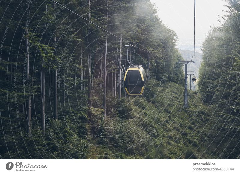 Cable car go to top of mountain among trees in forest on summer sunny day cable transport lift travel tourist transportation hill nature vacation panorama