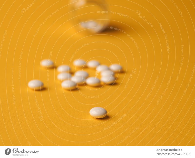 White pills on a yellow background table help vitamin pill healthy heap healthcare antibiotic treatment capsule medical pharmaceutical sickness medicinal drug