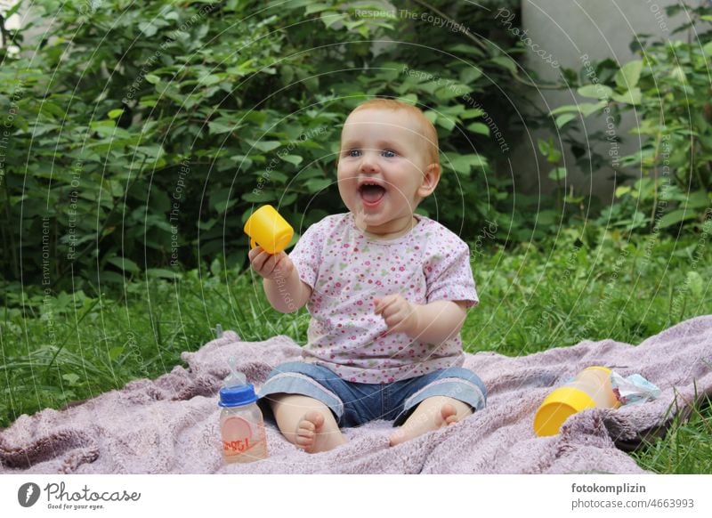 redhead baby / toddler sitting on blanket in greenery and laughing brightly Baby Toddler Laughter cheerful fortunate Joy Child Happiness Small Cute Happy