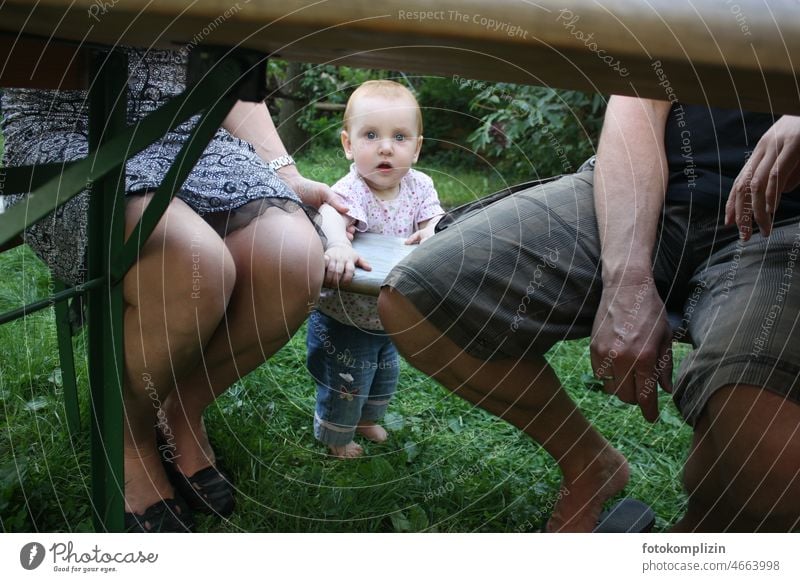 Toddler between mother and father under a beer table Parents Baby Father Mother parental leave Family & Relations Adults Child Together between them Garden