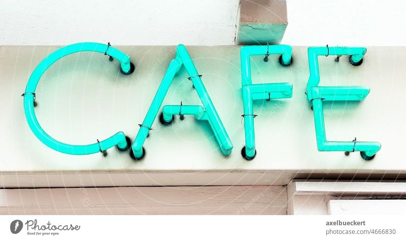 cafe neon sign in blue green coffee coffeehouse restaurant cyan signage drink establishment gastronomy glowing illuminated lettering word bistro text business