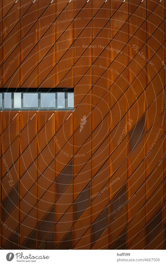 Row of windows in a rusty steel facade Abstr Architecture Rust rusty metal Cladding diamond pattern Modern architecture Building Facade Pattern Abstract