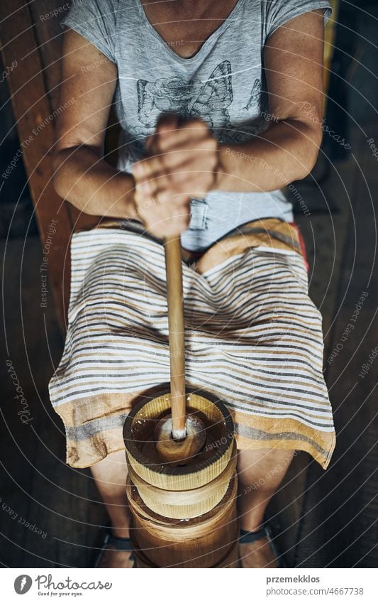 Woman making butter with butter churn. Old traditional method making of butter churner old rustic vintage wood brown container tool milk rural equipment