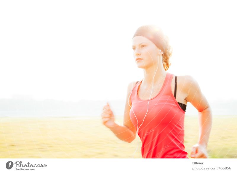 Woman is running in the sunny natur with headphones on Sports Fitness Sports Training Track and Field Sportsperson Jogging Feminine Young woman
