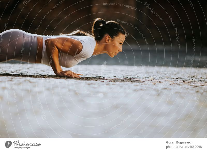 Young woman doing puhsups on the street active activity adult athlete athletic beautiful body caucasian city confident cute determination determined exercise