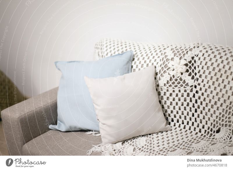 https://www.photocase.com/photos/4670818-pillows-on-a-couch-near-white-wall-light-blue-and-gray-pillows-and-knitted-blanket-on-a-beige-sofa-in-scandinavian-minimalist-style-apartment-interior-home-decor-with-copy-space-on-top-dot-photocase-stock-photo-large.jpeg