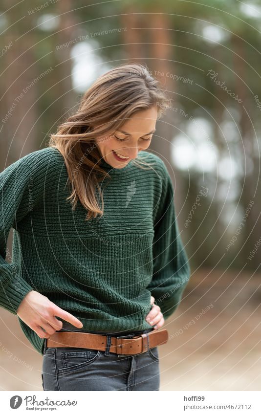 Portrait of smiling woman looking to the ground portrait Smiling Strand of hair pleased Face of a woman Adults melancholy Feminine Young woman Mysterious