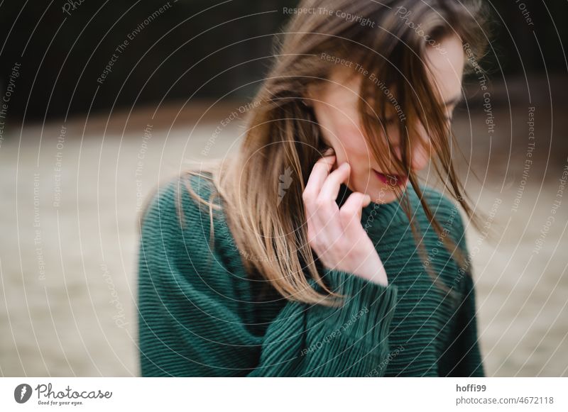 blurred portrait of woman with motion blur and blowing hair Movement Strand of hair Face of a woman Adults melancholy Dream Feminine Young woman Mysterious