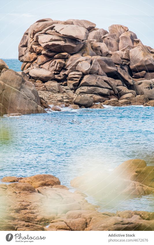 Shore with rocks near sea coast shore nature water stone seaside seashore waterside formation summer aqua rocky waterfront floral scenery summertime seacoast