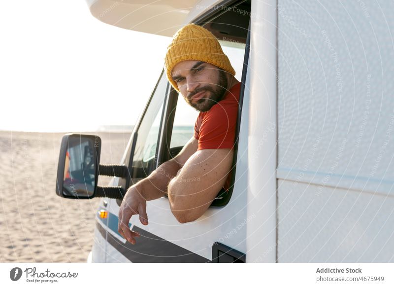 Hipster sitting in trailer on beach in summer man camper travel van sunset hipster traveler caravan male vacation seaside parked holiday adventure freedom guy
