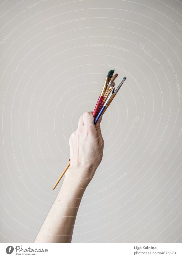 Hand holding paint brush, Stock image