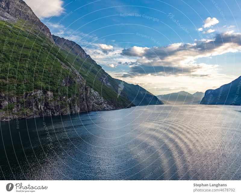 Impression from cruise ship on the way through Geiranger fjord in Norway at sunrise in summer Seven Sisters waterfall morning view sea norge mountain outdoors