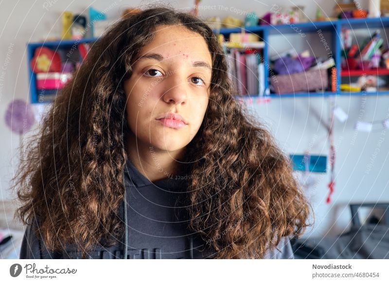 Portrait of a 13 year old girl with long hair in her bedroom, acne in her skin teenager caucasian isolated home brunette portrait 13 - 18 years