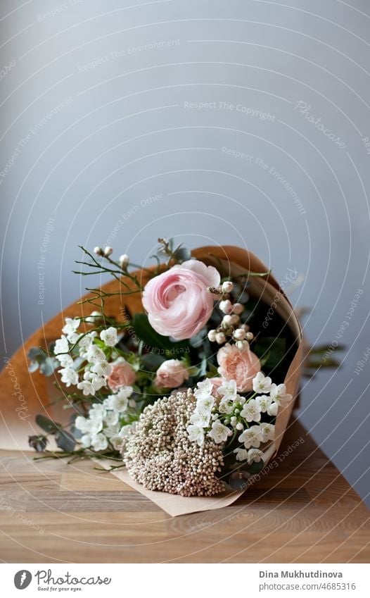 Bouquet of small white flowers and wooden hearts Stock Photo by katrinshine