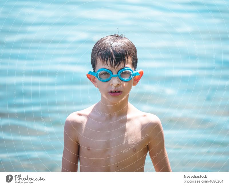 Portrait of a caucasian 6 year old boy on the beach wearing goggles, summer holidays concept portrait isolated vacation child Boy (child) Portrait photograph