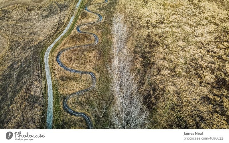 Elevated view of the spiral river with hiking trail Autumn hike meadows Colour Nature Water country Meadow background Spiral trees seasonal Drone outside