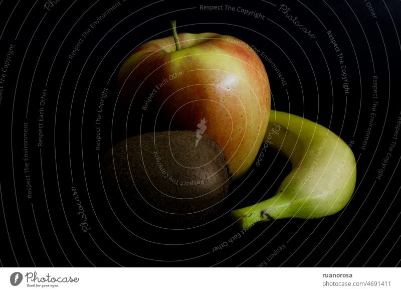 Dark mood still life with apple, banana and kiwi stilllife dark mood fruits Fruit Juicy Food contrast Nutrition Fresh Healthy Eating black yellow red