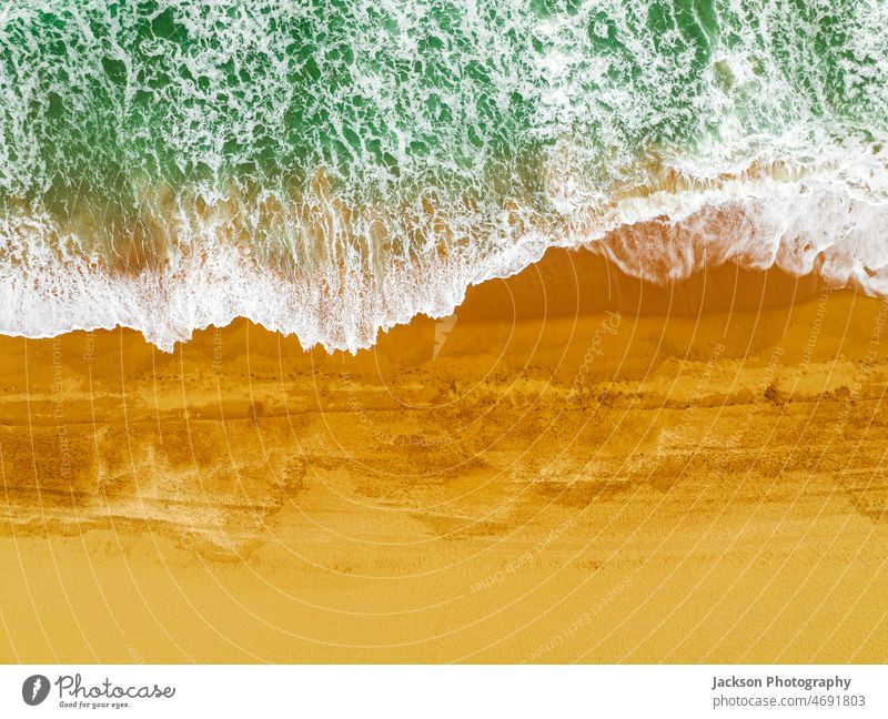 Top view of waves crushing on sandy beach in Albufeira, Algarve, Portugal albufeira ocean nature copy space vibrant outdoor nature background algarve portugal