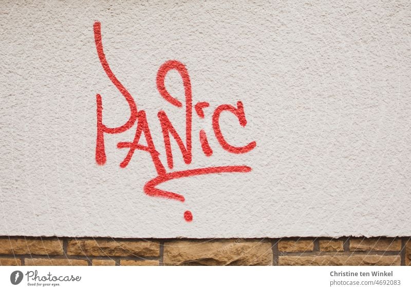 PANIC is written in red color on the white painted facade panicky Panic house wall House (Residential Structure) Rendered facade Facade Sign Wall (building)