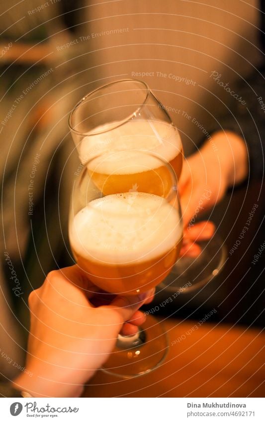 friends cheering with beer glasses, drinking beer or cider together with friends at the bar Drinking Alcoholic drinks Beverage Beer glass Colour photo Thirst