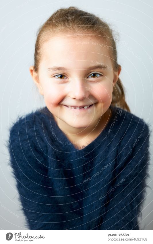Portrait of adorable little girl. Cute small child looking at camera. Portrait of girl wearing blue sweater portrait cute person sweet smile happiness face
