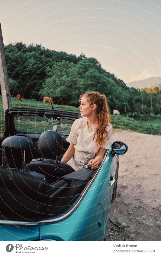 Girl and car without roof. Counryside woman driver auto people beauty vehicle person automobile transportation road driving hair outdoors fashion travel sitting