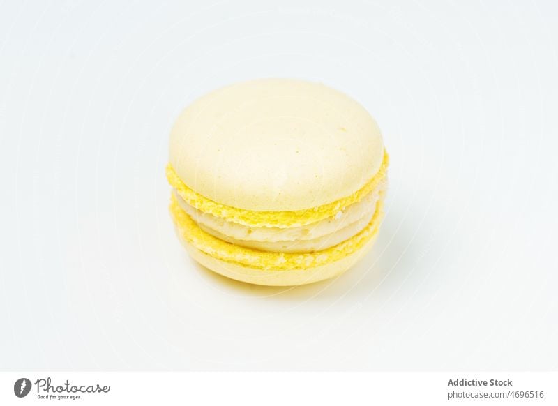 Lemon macaroon with filling on table macaron lemon vanilla white dessert sweet confection confectionery indulge treat food flavor fresh tasty delicious yummy