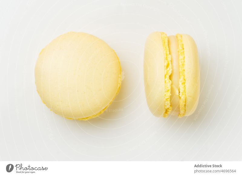 Lemon macaroons with filling on table macaron lemon vanilla dessert sweet confection confectionery indulge treat food flavor fresh tasty delicious yummy